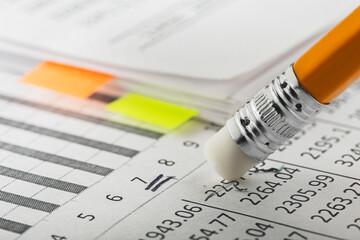 Accounting document with eraser erases blots in the document and checking financial chart. Concept...