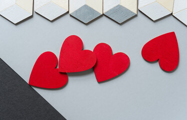 hand painted 3d cubes (hexagons) and red hearts on gray paper background