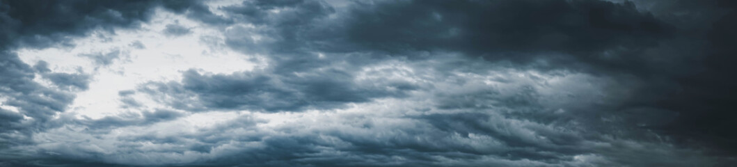 Dark cloudy sky before thunderstorm panoramic background. Storm panorama, Panorama view of overcast...