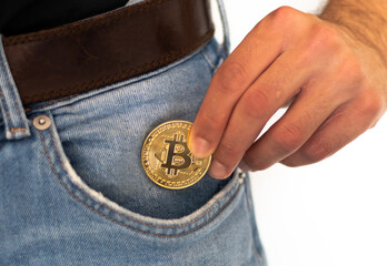 Obraz premium man putting crypto bitcoin in pocket, crypto currency business,investment and savings concept photo