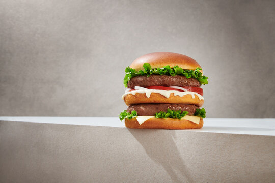 Appetizing double burger on gray background