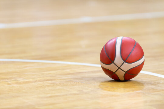 Basketball on hardwood court floor. Professional sport concept