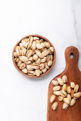 pistachios nuts in wooden bowl