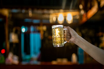 hand holding a glass of beer
