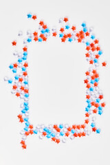 beautiful frame of blue, red and transparent stars on a white background. banner for the celebration of Independence Day on July 4th. space for text, flat lay, vertical frame