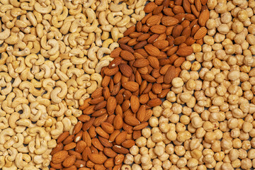 Close-up of nuts background: cashews, hazelnuts, almonds. Healthly food. A source of vitamins, microelements.