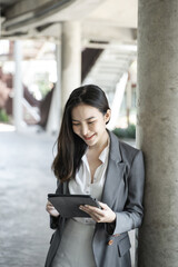 Obraz premium Happy Confident young asian businesswoman working with tablet Start up small business owner. business successful technology concept