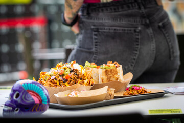 Traditional Mexican food in a fast food cafe with a skull at the table