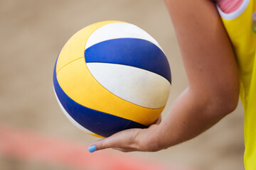 Volleyball game. Beach volleyball ball in hands.