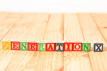 Spectacular wooden cubes with the word GENERATION X on a wooden surface.