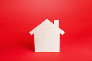 Obraz na płótnie Canvas Empty blank wooden house on red background. Buying and selling real estate. Housing, realtor services. Renovation and home improvement. Short and long term rentals. Mortgage loan. Building maintenance