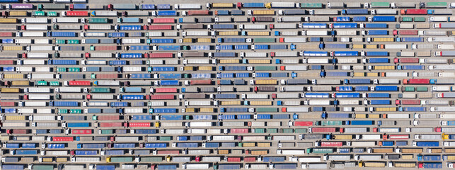 Obraz premium Trucks stand in line to the terminal.