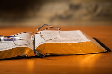 Open Bible with Pen and Eyeglasses