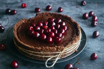 Pie with chocolate and cherries. Delicious cake on a plate