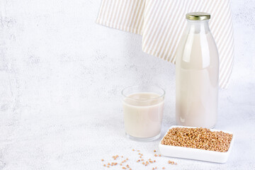 Buckwheat milk in glass bottle and glass.