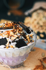 Dessert. Yoghurt dessert with chocolate and peanuts. Vintage dessert with cinnamon. Dessert served on a newspaper.