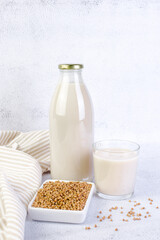 Buckwheat milk in glass bottle and glass.