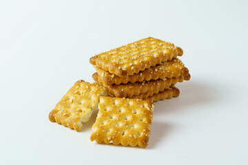 Close up stack of sugar and sesame crackers isolated on white background. 