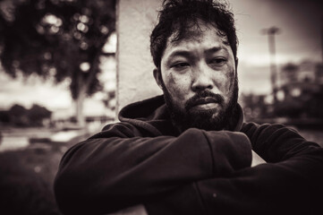 Asian man is homeless at the side road,A stranger has to live on the road alone because he has no family.