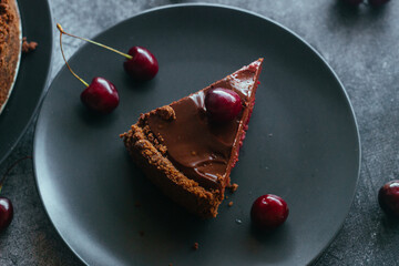 Pie with chocolate and cherries. Delicious cake on a plate