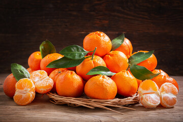 Fresh mandarin oranges fruit or tangerines on a wooden background