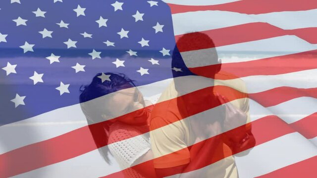 Animation of american flag over african american couple embracing at beach