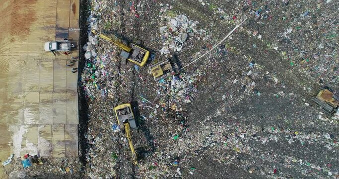 Garbage trucks are working in the waste sorting plant.