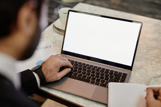 High Angle Close Up Of Successful Businessman Using Laptop With Blank White Screen While Working In Hotel Lobby, Copy Space