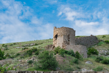 Fototapeta na wymiar View tower of Chembalo fortress. Medieval architecture monument, landmark. Ruined stone Genoese fortress in Balaklava in Crimea 