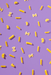 Unique composition with farfalle, canelloni and macaroni. . Fun and bright food concept. Minimal pattern.