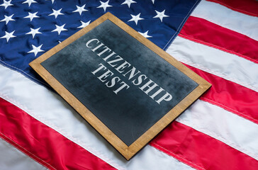 Citizenship test on the blackboard and USA flag.