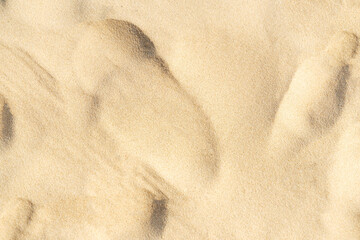 Sand texture on the beach. Brown beach sand for background.