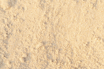 Sand texture on the beach. Brown beach sand for background.