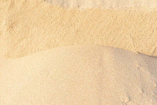 Sand texture on the beach. Brown beach sand for background.