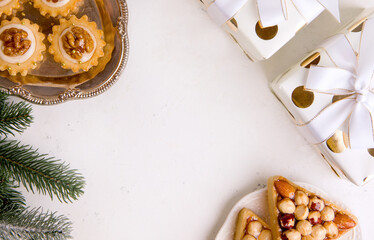 Background for new year or christmas. Cookies, Christmas tree, gifts on a white table