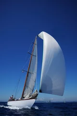 Tuinposter vintage sailboat with white spinnaker sailing downwind © Giovanni Rinaldi