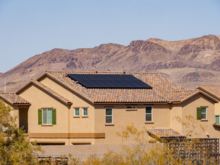 Sunny view of a two stories house with solar panel