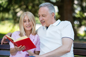 Couple reading a book in the park