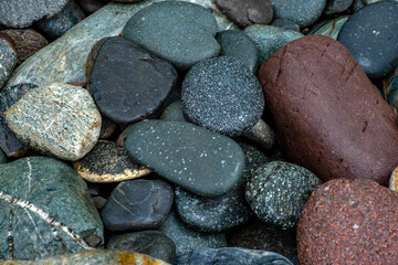 Abstract background texture of multicolored beautiful stones. Beautiful wet pebbles.