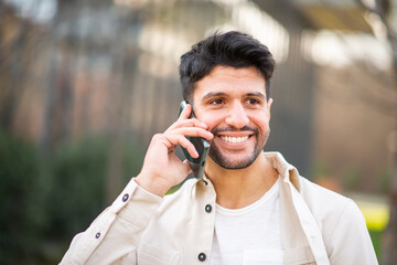 Young man talking on the phone outdoors