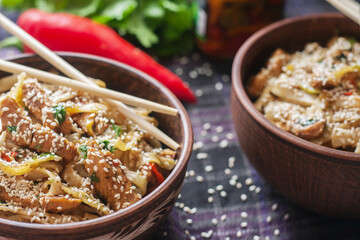 chinese food in a plate with chopsticks