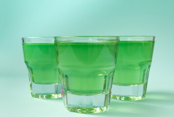 Sweet dessert, kiwi jelly in glass glasses on a mint background