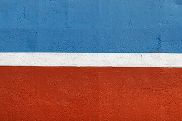 Blue-red side of the ship with a white stripe