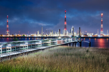 View on large petrochemical production plant on riverbank at twilight, Port of Antwerp