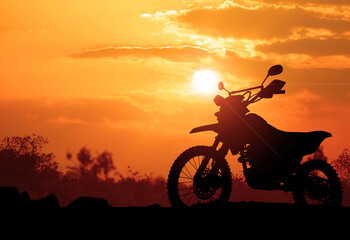 Motocross silhouette taking an evening adventure. Evening. Adventure concept.