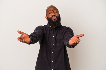African american man with beard isolated on pink background folding lips and holding palms to send air kiss.