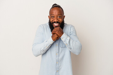 African american man with beard isolated on pink background praying for luck, amazed and opening mouth looking to front.