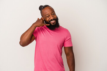 African american man with beard isolated on pink background showing a mobile phone call gesture with fingers.