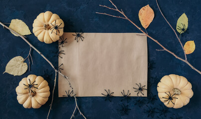 Halloween grunge dark blue holiday background, pumpkins, dry branches and orange leaves decorations. Autumn composition frame, party invitation card, flat lay, copy space.