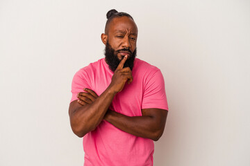 African american man with beard isolated on pink background looking sideways with doubtful and skeptical expression.